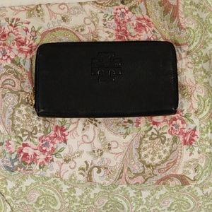 8 inches by almost 4 1/2 inches, black Tory Burch, leather, mint condition